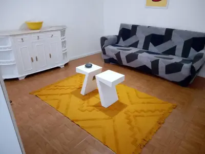 a living room with white furniture and a flat screen tv at Nice Belmonte Flat in Porto