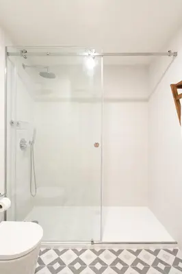 a bathroom with a shower with a glass door at VIVA Central Downtown Studio in Porto
