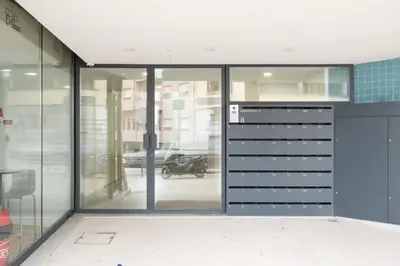 a building with glass doors and a motorcycle in the background at VIVA Central Downtown Studio in Porto
