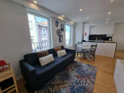 a living room with a couch and a table at Ponte & Morro Apartment in Vila Nova de Gaia
