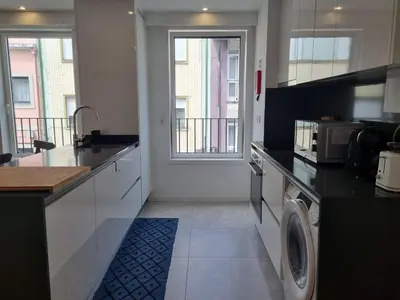 a kitchen with a washer and dryer in it at Ponte & Morro Apartment in Vila Nova de Gaia