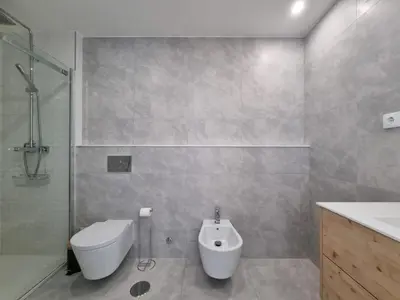 a bathroom with a toilet and a shower and a sink at Ponte & Morro Apartment in Vila Nova de Gaia