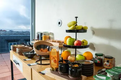 a counter with fruit on three tiers in a kitchen at Akeah Porto Centro in Porto