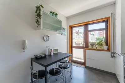 a dining room with a table and chairs and a window at GuestReady - Home Comforts in Porto in Porto