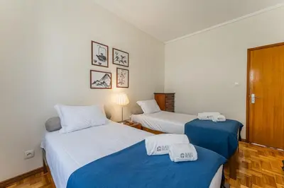 two beds in a room with blue and white at GuestReady - Home Comforts in Porto in Porto