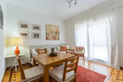 a living room with a table and a couch at GuestReady - Home Comforts in Porto in Porto