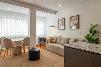 a living room with a couch and a table at Stylish & Cozy 1BR with AC by LovelyStay in Porto