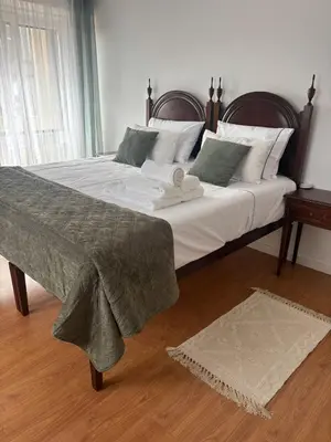 a bedroom with a large bed with a blanket on it at Porto Family Home Apartment in Porto