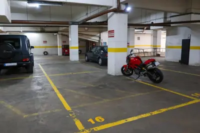 a red motorcycle parked in a parking garage at Porto Family Home Apartment in Porto