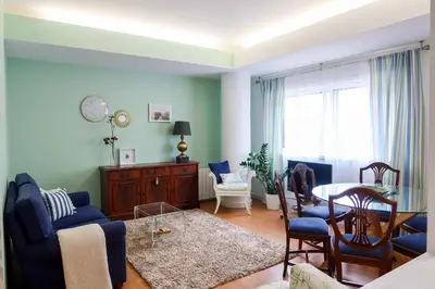 a living room with a table and a dining room at Porto Family Home Apartment in Porto