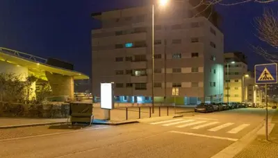 a parking lot with a street light in front of a building at Porto H Dragão in Porto