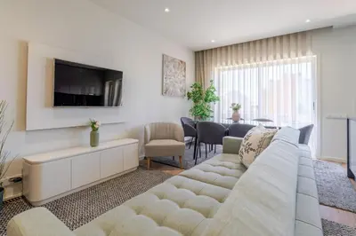 a living room with a couch and a tv at Central & Stylish Apartment by HostWise in Porto