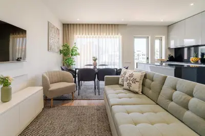 a living room with a couch and a dining room at Central & Stylish Apartment by HostWise in Porto