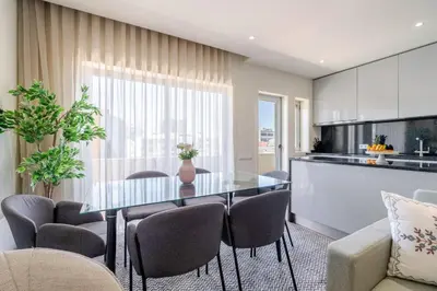 a kitchen and dining room with a table and chairs at Central & Stylish Apartment by HostWise in Porto