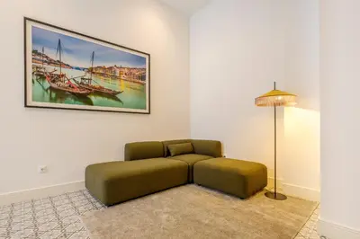 a living room with a couch and a picture on the wall at Art Deco 14 Luxury Apartment Downtown Metro AC in Porto