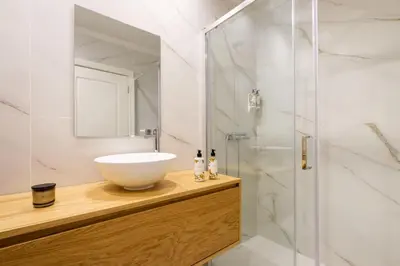 a bathroom with a sink and a shower at Art Deco 24 Luxury Apartment Downtown Metro AC in Porto