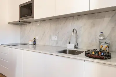 a kitchen counter with a sink and a microwave at Art Deco 24 Luxury Apartment Downtown Metro AC in Porto