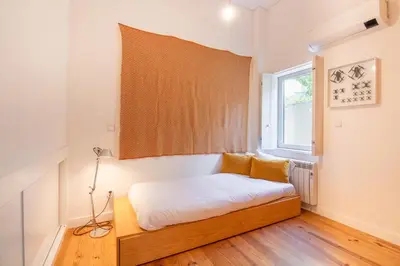 a small bedroom with a bed and a window at Chic Campanhã Home w Free Parking by LovelyStay in Porto