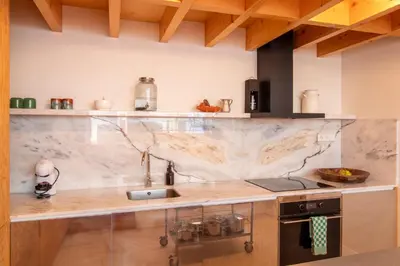 a kitchen with a marble counter top and a sink at Chic Campanhã Home w Free Parking by LovelyStay in Porto
