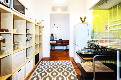 a kitchen with a refrigerator and a kitchen rug at Love&Life - Cosy&Central in Porto