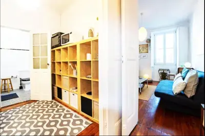 a living room with a couch and a book shelf at Love&Life - Cosy&Central in Porto