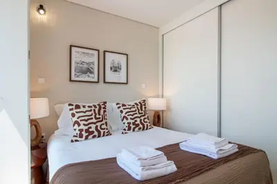 a bedroom with a bed with towels on it at Stylish & Sunny 2BR near Heroísmo by LovelyStay in Porto
