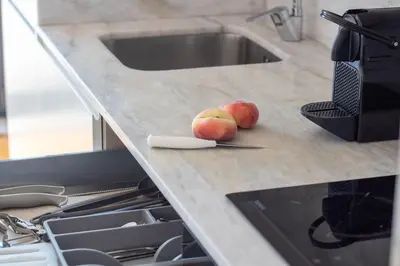 two apples sitting on top of a kitchen counter at Stylish & Sunny 2BR near Heroísmo by LovelyStay in Porto