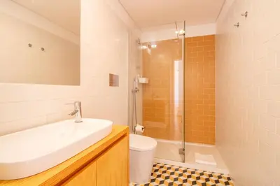 a bathroom with a sink and a shower and a toilet at Stylish & Sunny 2BR near Heroísmo by LovelyStay in Porto