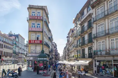 a group of people walking down a street with buildings at Luxury Apartment In Cardosas in Porto