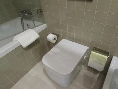 a bathroom with a toilet and a sink and a tub at Luxury Apartment In Cardosas in Porto