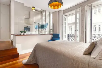 a bedroom with a bed and a kitchen at Luxury Apartment In Cardosas in Porto