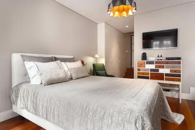a bedroom with a bed and a dresser and a tv at Luxury Apartment In Cardosas in Porto