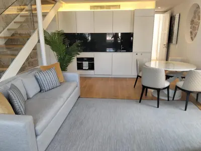 a living room with a couch and a table at Timeless Elegance Boutique for two in Porto