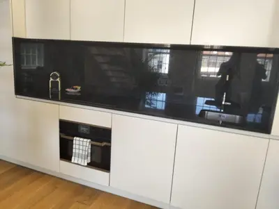 a kitchen with white cabinets and a black counter top at Timeless Elegance Boutique for two in Porto