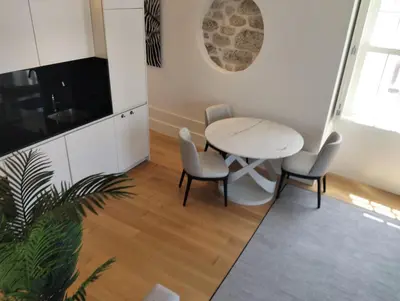 a dining room with a table and chairs at Timeless Elegance Boutique for two in Porto