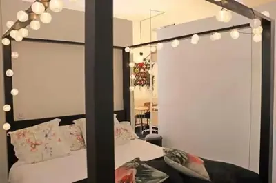a bedroom with a bed with a mirror and lights at Formosa IN in Porto