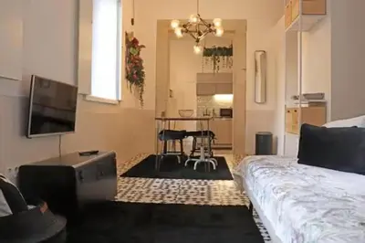 a living room with a bed and a table with chairs at Formosa IN in Porto
