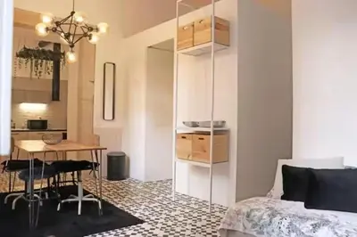a bedroom with a bed and a table and a kitchen at Formosa IN in Porto