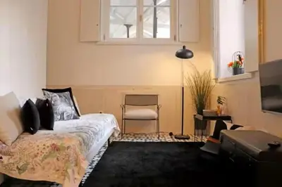 a bedroom with a bed and a chair and a window at Formosa IN in Porto