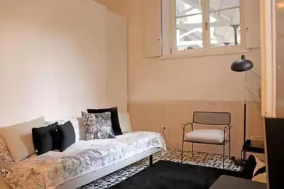 a bedroom with a bed and a chair and a window at Formosa IN in Porto