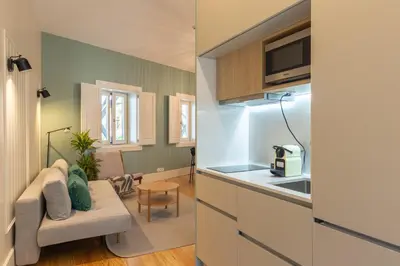 a kitchen and living room with a couch and a table at Porto Haven - Under the Luís I Bridge in Porto