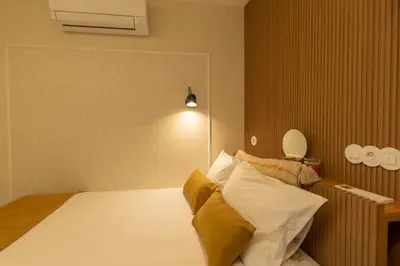 a bedroom with a bed with yellow and white pillows at Porto Haven - Under the Luís I Bridge in Porto