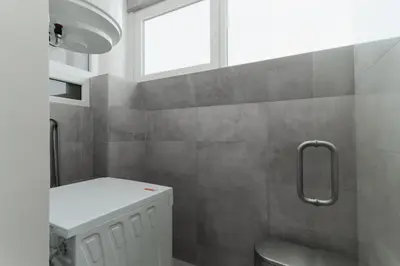 a bathroom with a sink and a toilet and a window at O Navegador in Porto