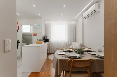 a kitchen and dining room with a table and chairs at Fernão de Magalhães in Porto