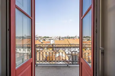 an open door with a view of a city at Aspasios Baixa Apartments in Porto
