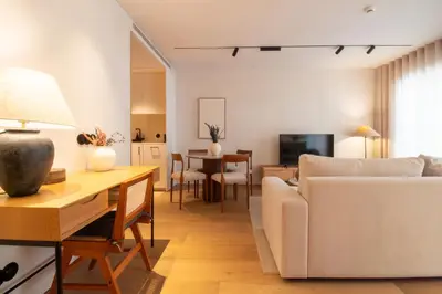 a living room with a white couch and a table at Verde Almada 3d by LovelyStay in Porto