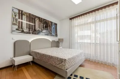 an empty street in a city with cars on the road at Apartamento de luxo Centro do Porto - ACE Residence in Porto