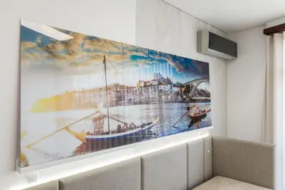 a living room with a desk and a chair at Apartamento de luxo Centro do Porto - ACE Residence in Porto
