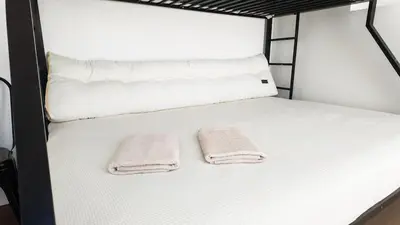 two towels sitting on top of a bunk bed at Bonfim Residence in Porto