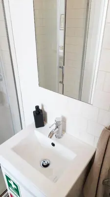 a bathroom with a white sink and a mirror at Bonfim Residence in Porto